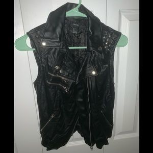 Faux leather sleeveless jacket.